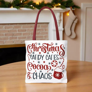 A white tote bag with a red handle, featuring a Christmas-themed design with text and illustrations related to holiday treats and festivities.