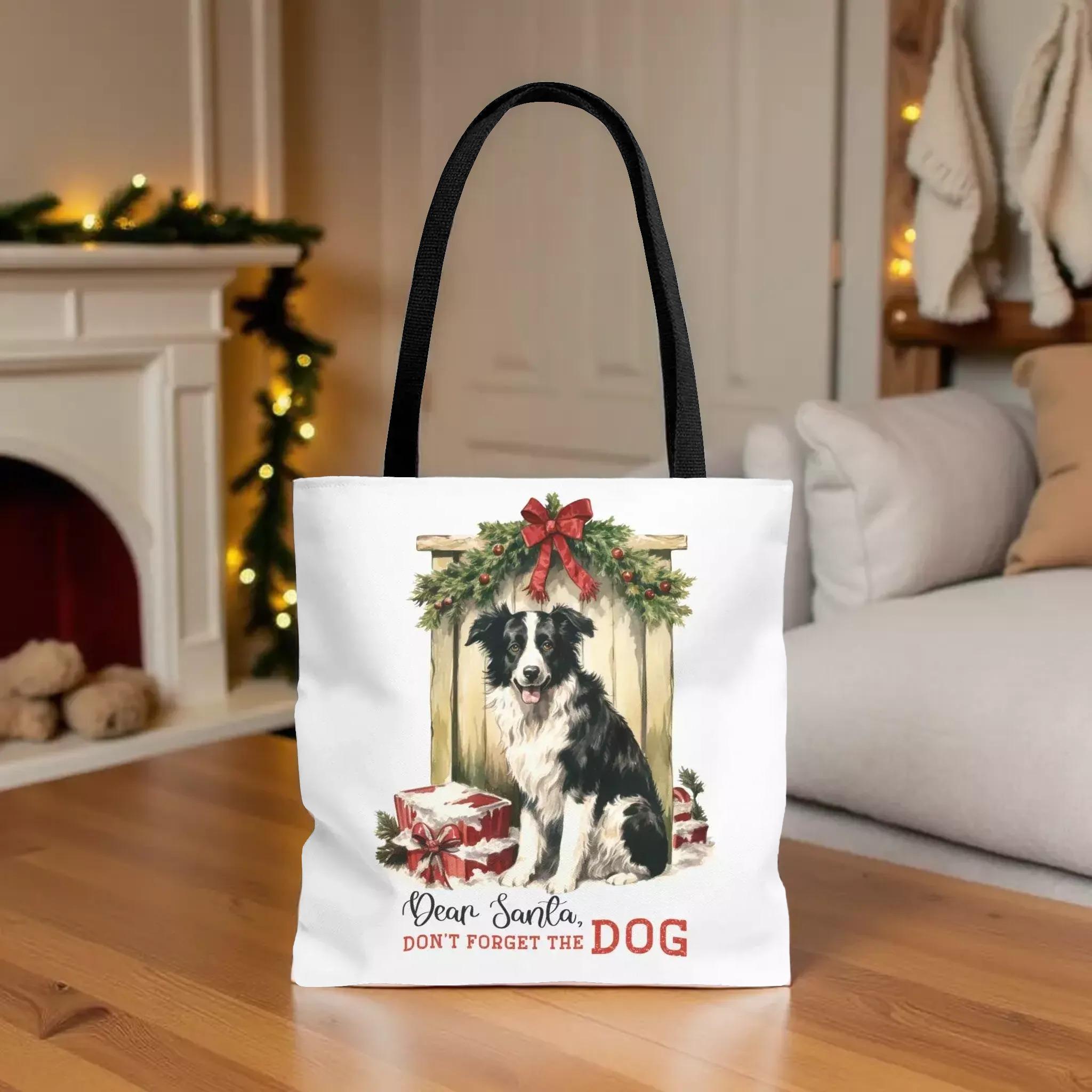 A white tote bag with a black handle and a printed image of a dog sitting in front of a Christmas wreath and presents.
