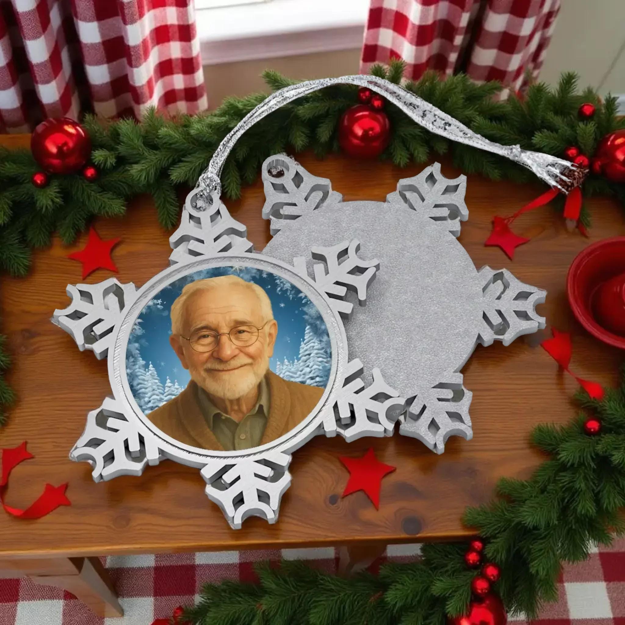 A silver snowflake ornament with a picture of an elderly man inside it.
