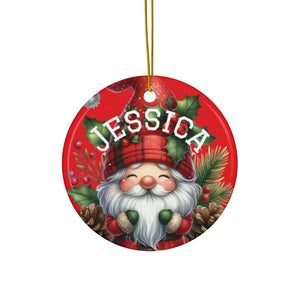 A red ornament featuring a smiling gnome wearing a red hat and surrounded by holly leaves, pine cones, and berries.