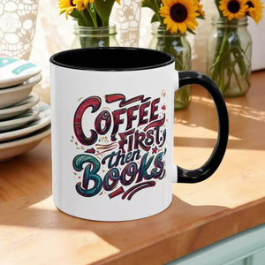 A white mug with a black handle, featuring a colorful and stylized text design that reads "Coffee first then books".