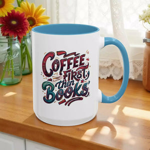 A white mug with a blue handle, featuring a colorful and artistic design with the text "Coffee first then books" printed on it.