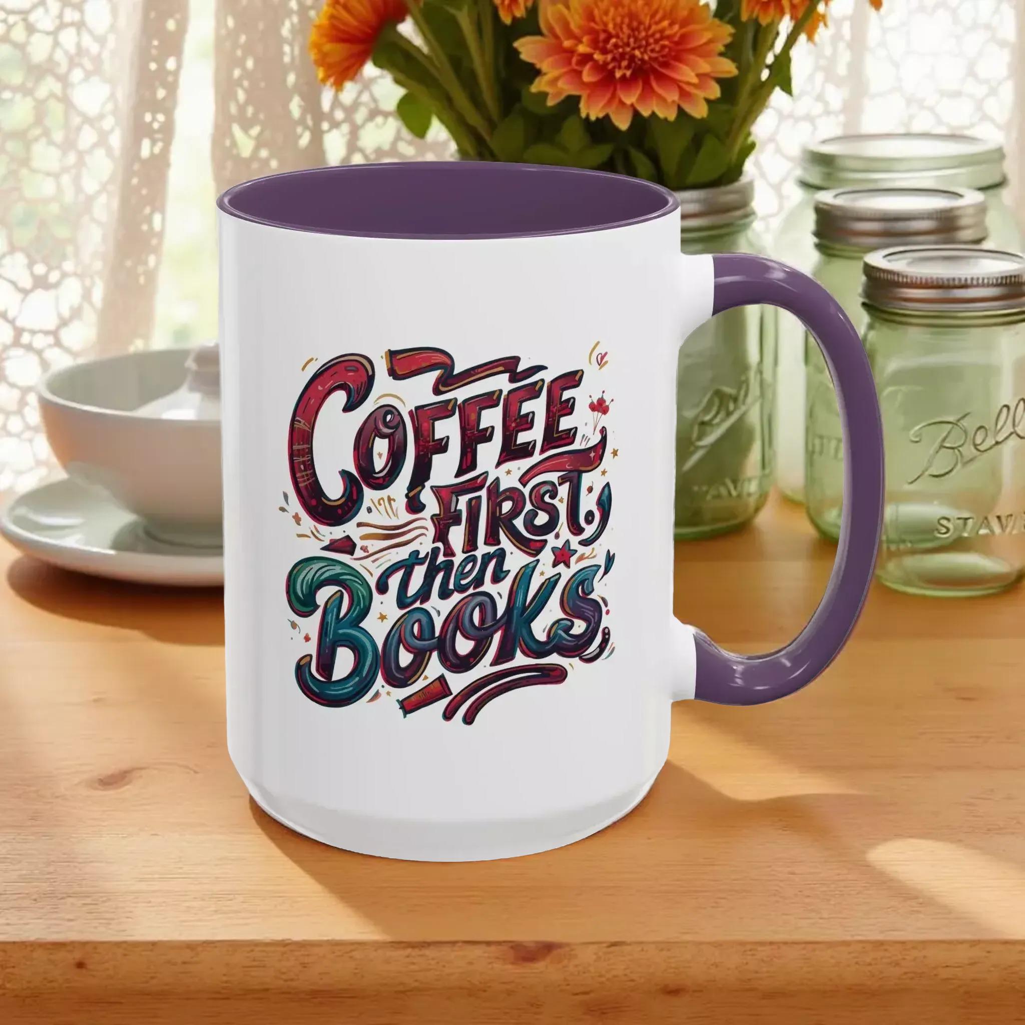 A white mug with a purple handle, featuring a colorful and stylized text design that reads "Coffee first then books".