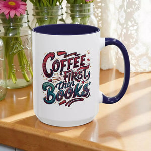 A white mug with a blue rim, featuring a colorful and artistic design with the text "Coffee first then books" printed on it.