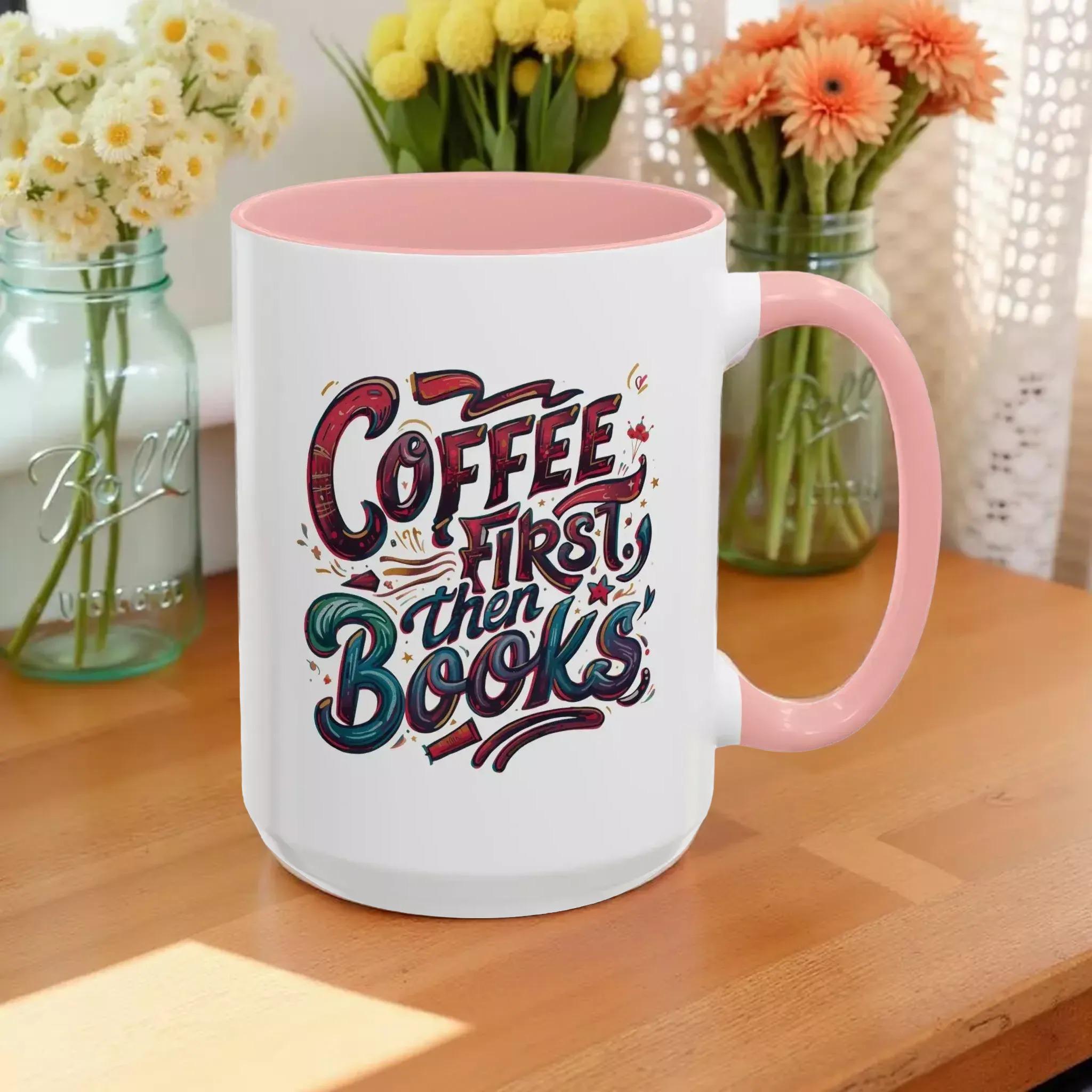 A white mug with a pink interior, featuring a colorful and playful design with text that reads "Coffee first then books".