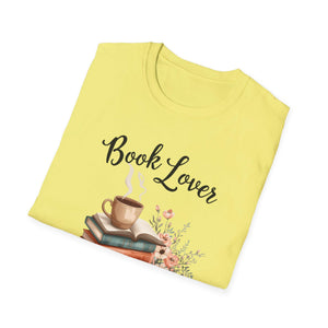 A yellow t-shirt with a printed design that includes a stack of books, a cup of coffee, and the text "Book Lover" printed on it.