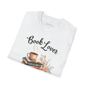 A white t-shirt with a printed design that includes a cup of coffee, a stack of books, and flowers. The text on the t-shirt says "Book Lover".