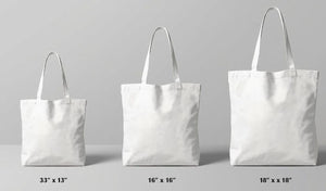 three white tote bags of different sizes, ranging from 33" to 18" in width.