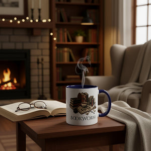 A white mug with a blue rim, featuring an illustration of a bookworm surrounded by various books, a cup of coffee, and other objects associated with reading and studying.