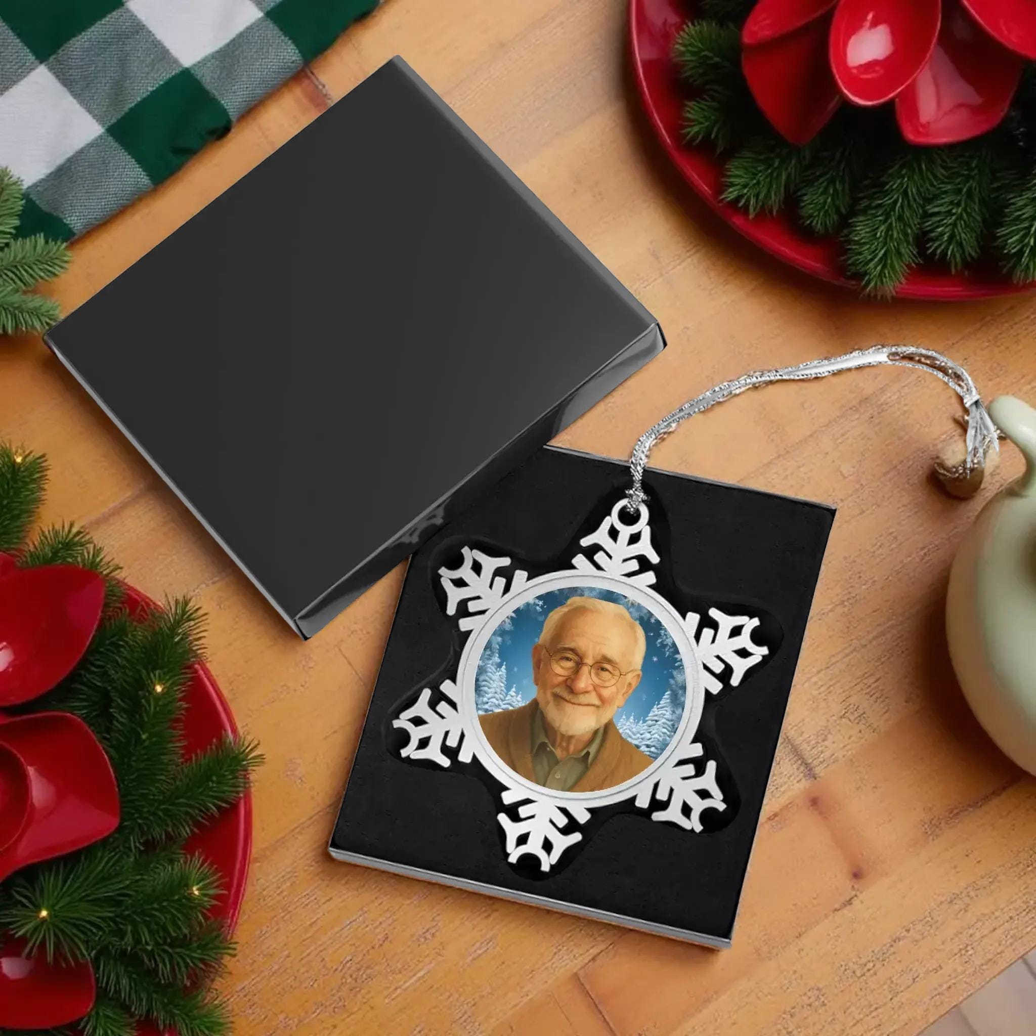 a black box with a silver snowflake ornament hanging from a string.