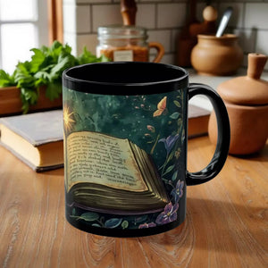 A black mug with an illustration of an open book surrounded by flowers and butterflies, set against a colorful, fantastical background.