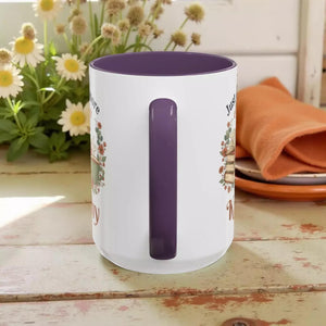 A white mug with a purple interior, featuring a floral design and the text "Just love knitting".