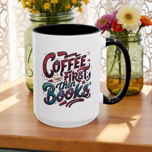 A white mug with a black handle, featuring a colorful and stylized text design that reads "Coffee first then books".