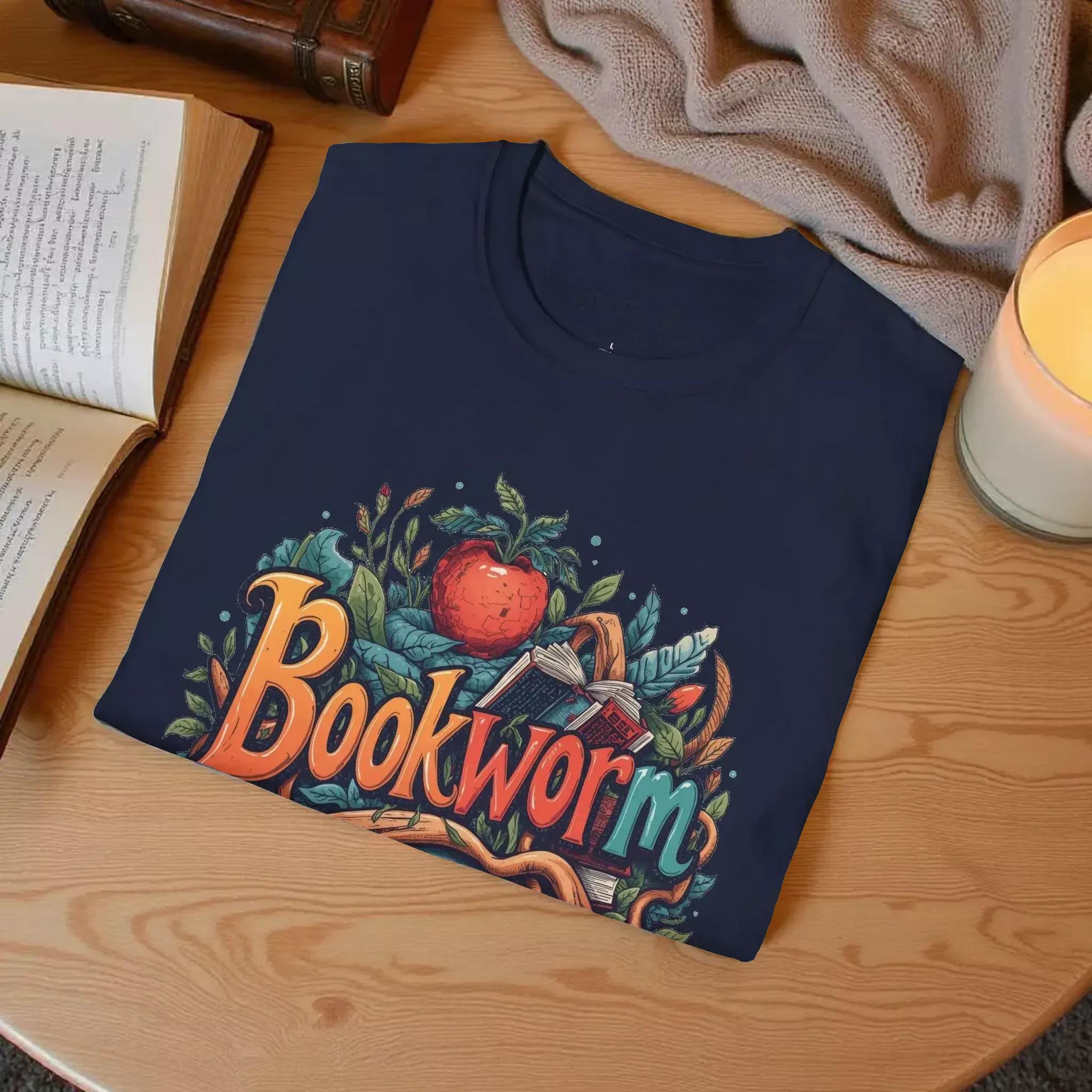 The image is a t-shirt with a colorful graphic design featuring the word "Bookworm" surrounded by various elements such as leaves, an apple, and a book.