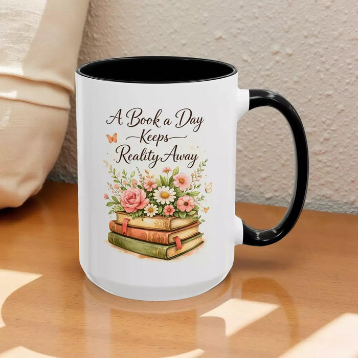 A white mug with a black handle, featuring a design of a stack of books with flowers on top.