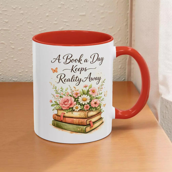 A white mug with a black handle, featuring a design of a stack of books with flowers on top.
