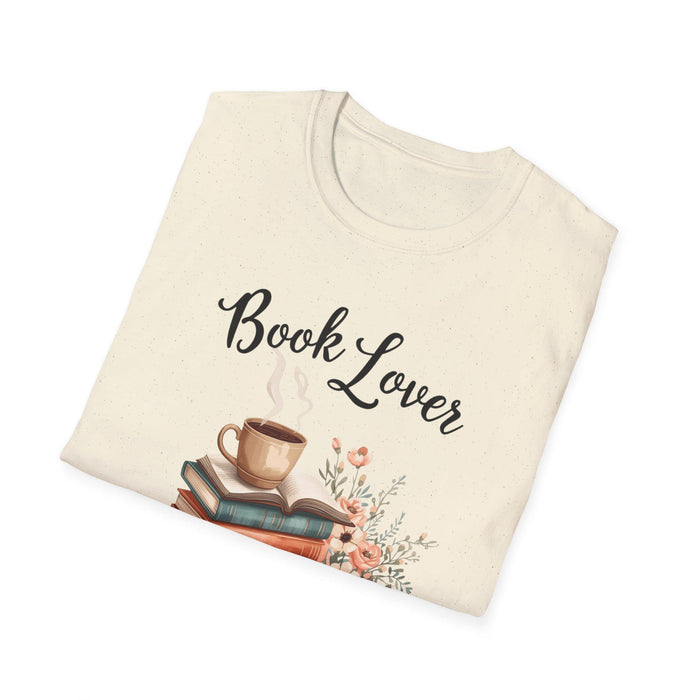 A beige t-shirt with a printed design that includes a cup of coffee, a stack of books, and flowers. The text on the t-shirt says "Book Lover".