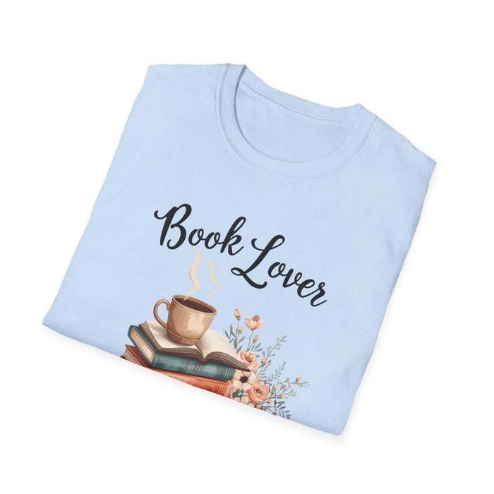 A beige t-shirt with a printed design that includes a cup of coffee, a stack of books, and flowers. The text on the t-shirt says "Book Lover".