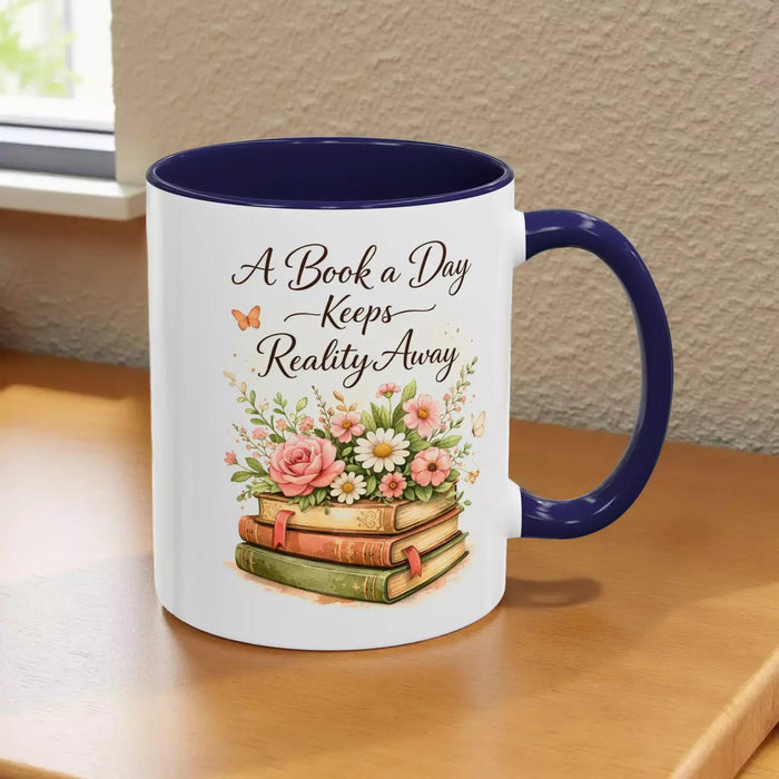 A white mug with a black handle, featuring a design of a stack of books with flowers on top.