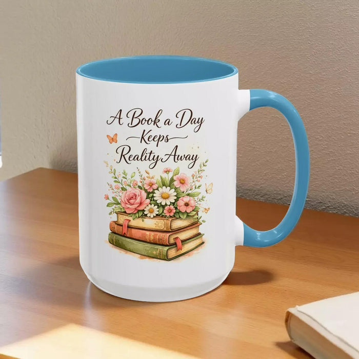 A white mug with a black handle, featuring a design of a stack of books with flowers on top.