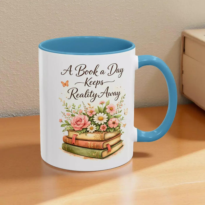 A white mug with a black handle, featuring a design of a stack of books with flowers on top.
