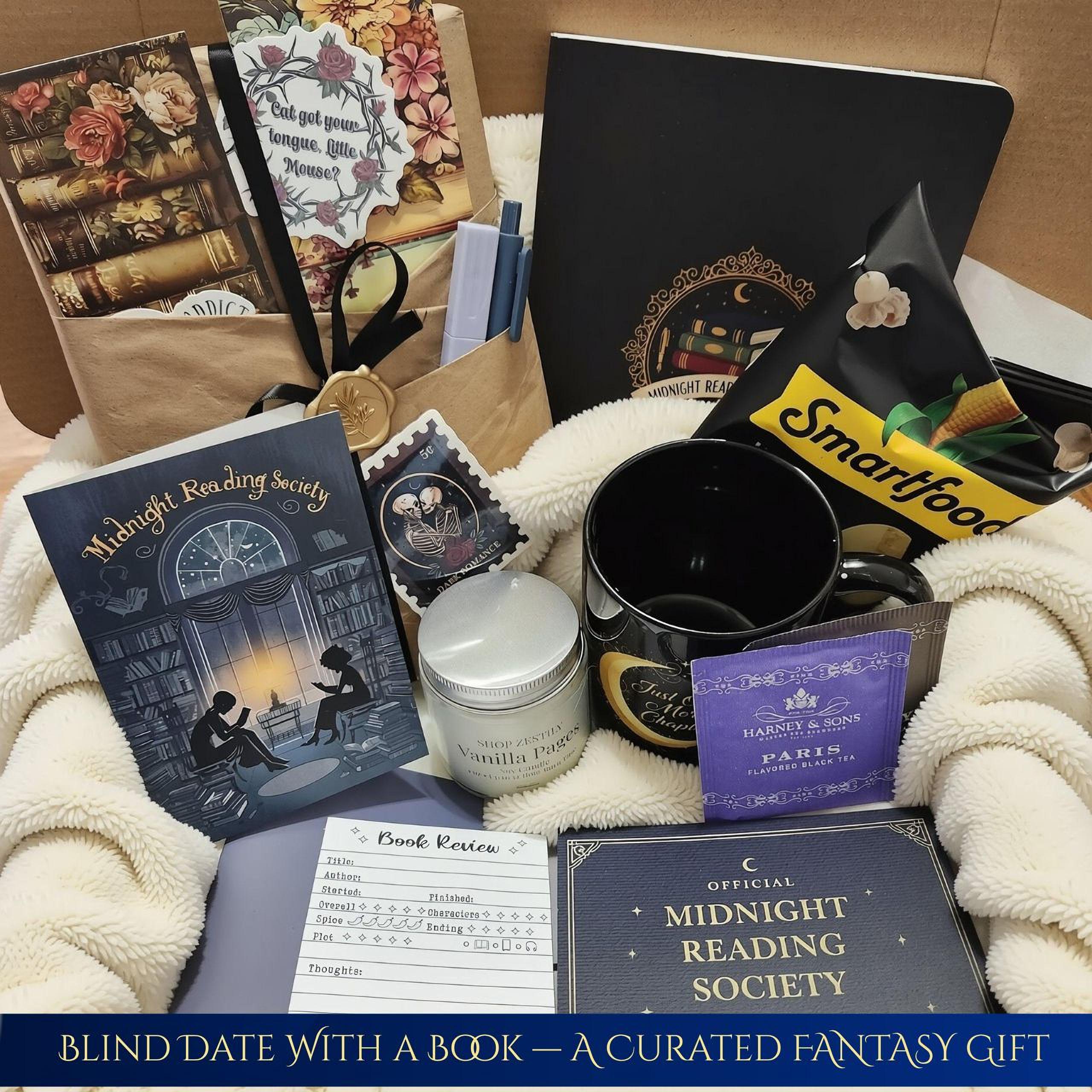 various items related to a nighttime reading society, including a book, a mug, a bag, and some snacks. The items are arranged on a surface, possibly a blanket or a table, suggesting a cozy and relaxing setting.