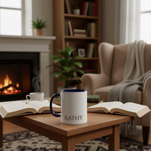 A white mug with a blue interior and handle, featuring the name "Kathy" printed on it.
