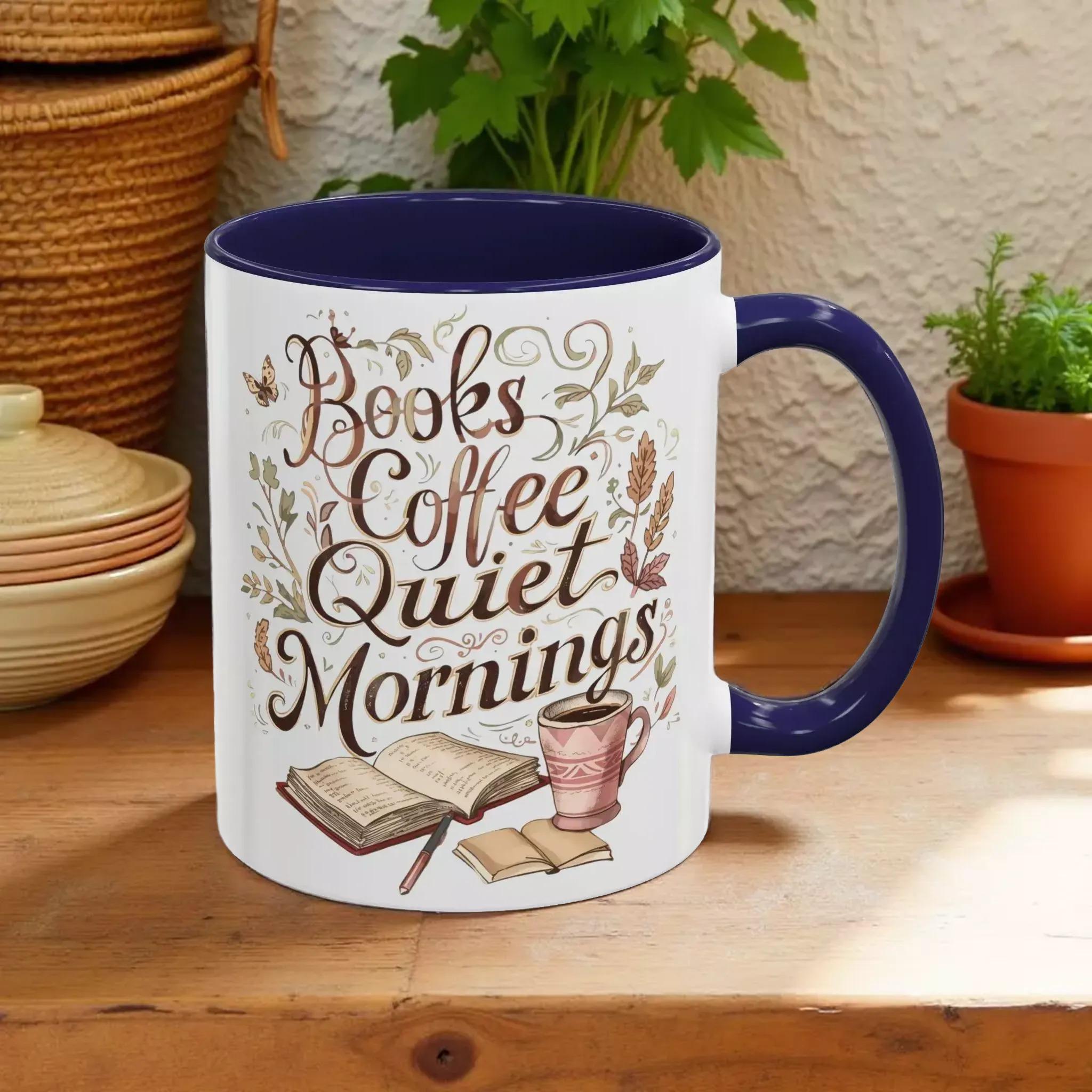 A white mug with a blue rim, featuring a design with the text "Books Coffee Quiet Mornings" and illustrations of a book, a cup of coffee, and a warm beverage.