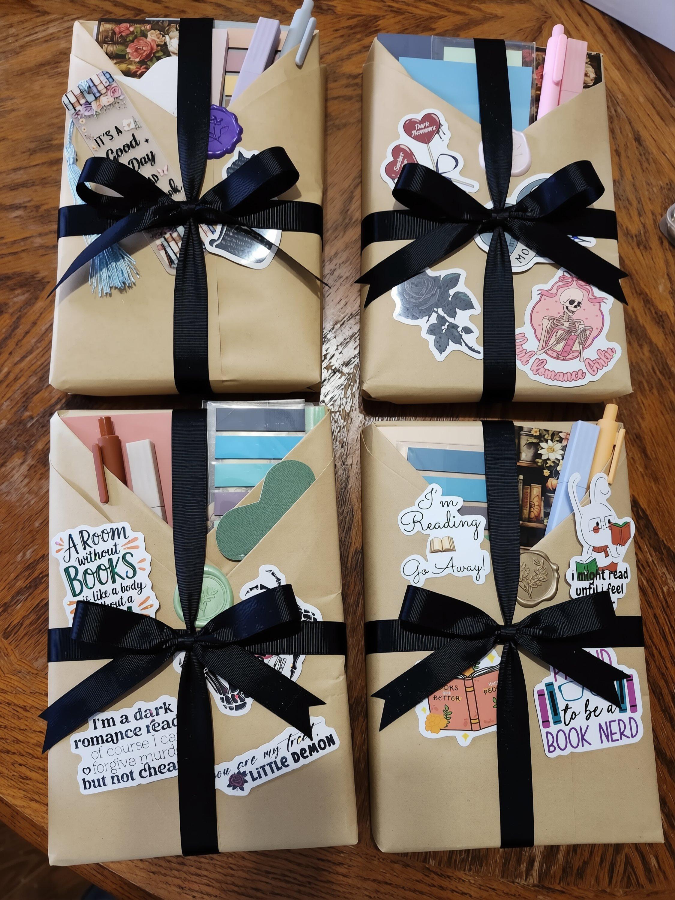 three envelopes with various stickers and decorations on them, placed on a wooden surface.