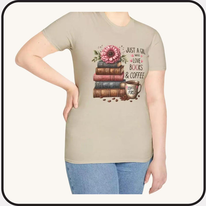 A smiling woman wearing a t-shirt with a graphic design of stacked books and coffee cups.