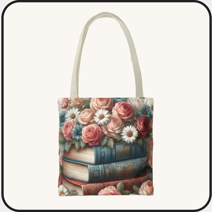 A tote bag with a floral design featuring a stack of books with roses and daisies on top.