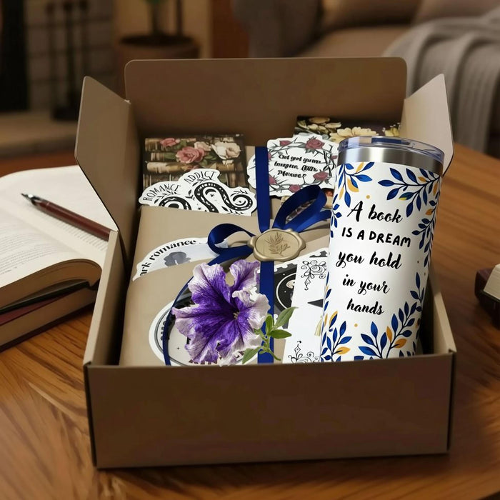 The image is a graduation gift box containing a book, a mug, and some tea bags, along with a congratulatory card and confetti.