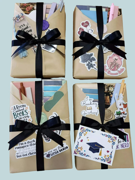 The image is a graduation gift box containing a book, a mug, and some tea bags, along with a congratulatory card and confetti.