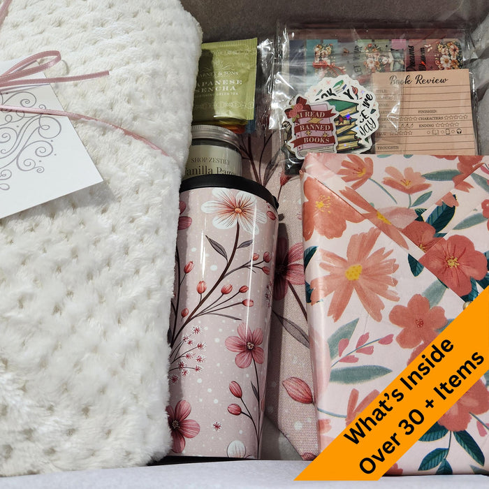 A box containing various items, including a book, snacks, candles, and other miscellaneous items, all wrapped in brown paper and tied with twine.