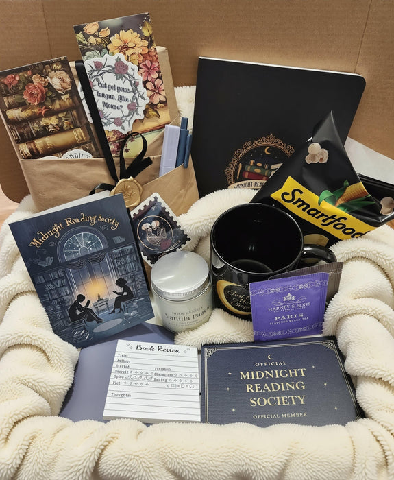 various items related to the "Dark Academia" theme, including a book, a mug, a candle, and other miscellaneous objects.