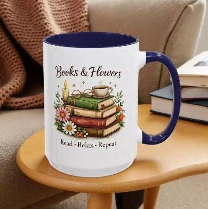 A tote bag with a floral pattern and a mug with a book and flower design, both placed on a stack of books.