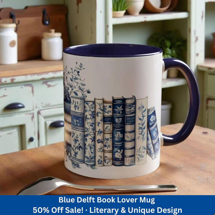 A white tote bag with a blue floral design and a stack of blue and white books, along with a matching blue and white mug, are displayed on a wooden surface.