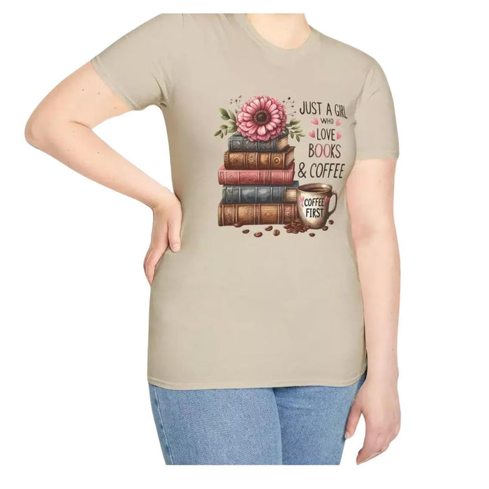 A smiling woman wearing a t-shirt with a graphic design of stacked books and coffee cups.