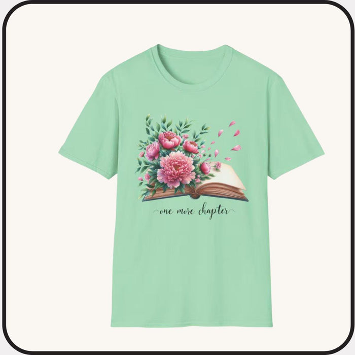A smiling woman wearing a t-shirt with a floral design and the text "one more chapter" is sitting on a wooden chair.