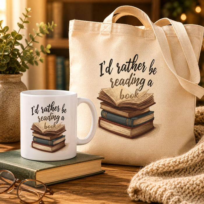A beige tote bag with a printed design on it, depicting a stack of books. The text on the bag reads "I'd rather be reading a book".