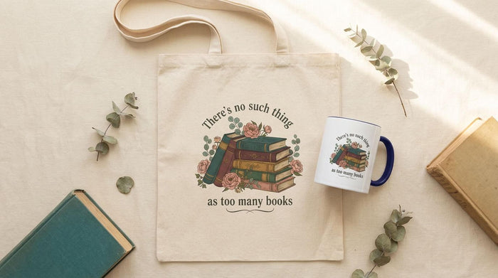 a tote bag and a mug with a printed design, including a stack of books and the text "There's no such thing as too many books" and "There's no such thing as too many books" on them. The items are placed on a table with some greenery, and there is a text overlay that reads "Tote Bag & Mug Gift Set" and "Buy the Tote & add the Mug".