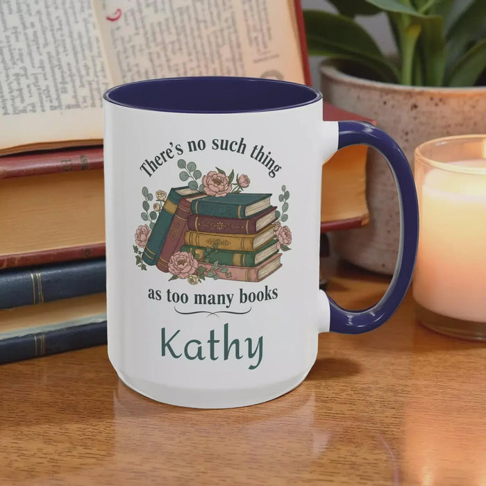 a tote bag and a mug with a printed design, including a stack of books and the text "There's no such thing as too many books" and "There's no such thing as too many books" on them. The items are placed on a table with some greenery, and there is a text overlay that reads "Tote Bag & Mug Gift Set" and "Buy the Tote & add the Mug".
