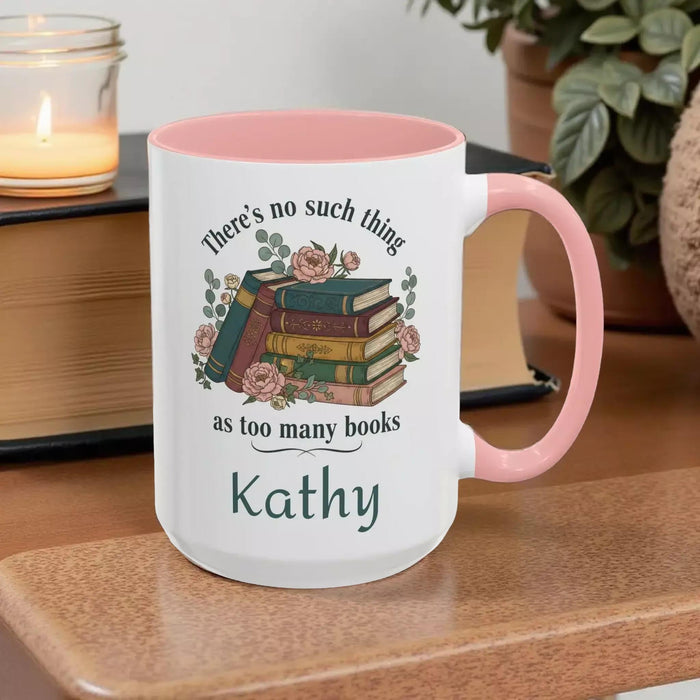 a tote bag and a mug with a printed design, including a stack of books and the text "There's no such thing as too many books" and "There's no such thing as too many books" on them. The items are placed on a table with some greenery, and there is a text overlay that reads "Tote Bag & Mug Gift Set" and "Buy the Tote & add the Mug".