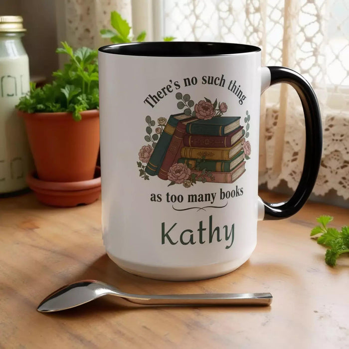 a tote bag and a mug with a printed design, including a stack of books and the text "There's no such thing as too many books" and "There's no such thing as too many books" on them. The items are placed on a table with some greenery, and there is a text overlay that reads "Tote Bag & Mug Gift Set" and "Buy the Tote & add the Mug".