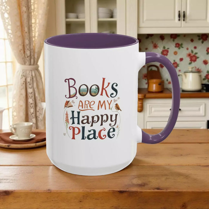 A tote bag and a mug with the text "Books are my Happy Place" printed on them, along with a book and a pen.