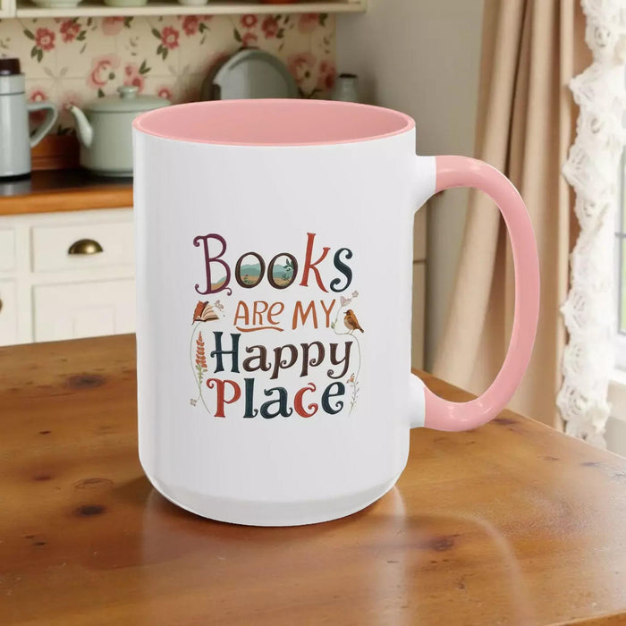 A tote bag and a mug with the text "Books are my Happy Place" printed on them, along with a book and a pen.