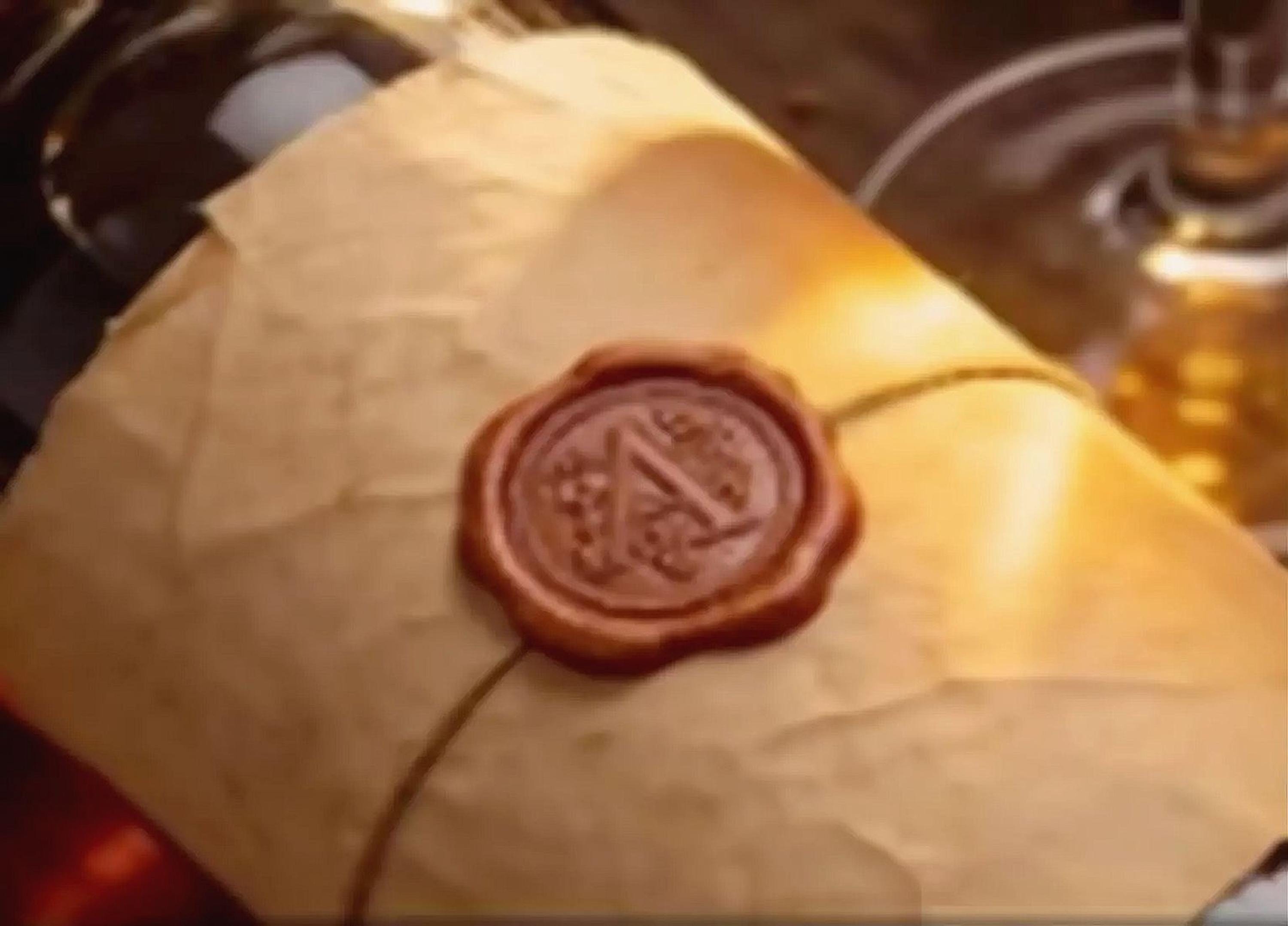A close-up image of a wax seal or wax stamp on a piece of paper, with a glass of wine visible in the background.