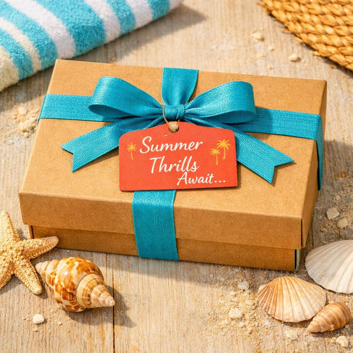 A box filled with various summer-themed items, including a book, a mug, a puzzle, and other beach-related objects, along with a sign that says "Summer Thrills Edition".