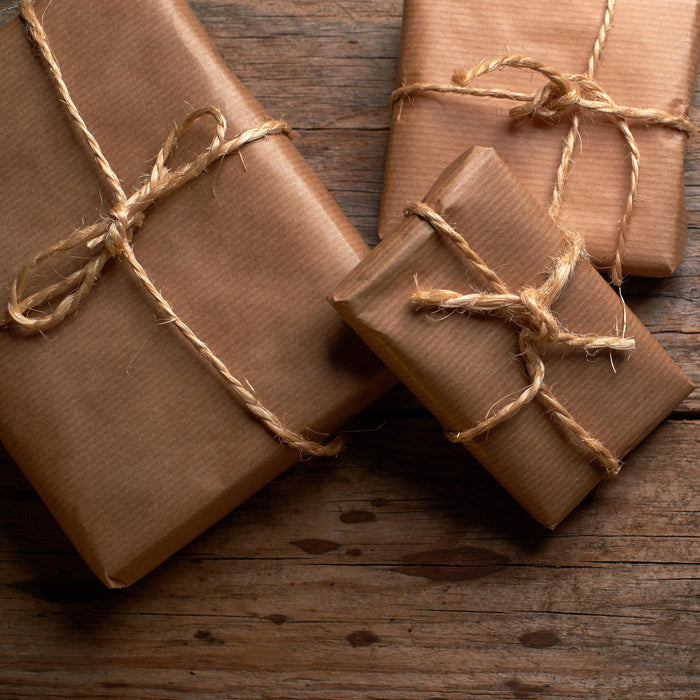 The image is a gift box containing various items related to summer activities, including a book, cookies, sunglasses, and other beach-themed items.