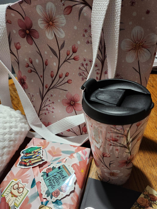 A box containing various items, including a book, snacks, candles, and other miscellaneous items, all wrapped in brown paper and tied with twine.